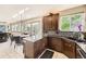 Lovely kitchen with granite counters, tile backsplash, stainless sink, and breakfast nook with views of the yard at 12693 W 82Nd Ln, Arvada, CO 80005