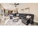 Cozy living room with a large sofa, modern ceiling fan, and views of the kitchen and stairs at 12693 W 82Nd Ln, Arvada, CO 80005