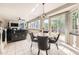 Bright living room with views of the backyard, tile floors, fireplace, and a modern ceiling fan at 12693 W 82Nd Ln, Arvada, CO 80005