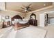Large main bedroom with wood trim, neutral walls, light carpet, and dark furniture at 12693 W 82Nd Ln, Arvada, CO 80005