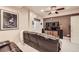Basement media room with comfortable seating, large screen TV, and ceiling fan at 12693 W 82Nd Ln, Arvada, CO 80005