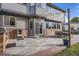 Relaxing patio area with a built-in grill, dining set, and ambient string lights for evening enjoyment at 12693 W 82Nd Ln, Arvada, CO 80005