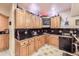 The wet bar boasts granite counters, ample wood cabinets, and stainless steel appliances at 12693 W 82Nd Ln, Arvada, CO 80005