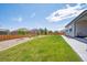 Large backyard with green lawn, stone border, wooden fence and some trees at 14670 Guernsey Dr, Mead, CO 80542