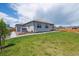 Large, grassy backyard with patio, shed and wooden fence, backing to other homes at 14670 Guernsey Dr, Mead, CO 80542