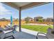 Well-manicured backyard with patio area, seating, and green lawn at 14670 Guernsey Dr, Mead, CO 80542
