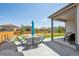 Backyard features manicured lawn, patio with seating, wooden fence and view of neighboring houses at 14670 Guernsey Dr, Mead, CO 80542