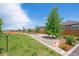 Beautifully landscaped backyard with lush green grass, river rock, stone accents, garden area, and a wooden fence at 14670 Guernsey Dr, Mead, CO 80542