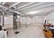 Unfinished basement with concrete floor, white walls and exposed ceiling beams at 14670 Guernsey Dr, Mead, CO 80542