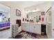 This bathroom features double sinks, storage, a shower, and a purple and grey rug at 14670 Guernsey Dr, Mead, CO 80542