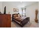 Comfortable bedroom with a queen-size bed, dresser, and neutral decor, offering a serene and relaxing atmosphere at 14670 Guernsey Dr, Mead, CO 80542