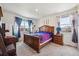 Comfortable bedroom with colorful bedding, two windows providing natural light, and classic furnishings at 14670 Guernsey Dr, Mead, CO 80542