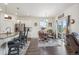 Bright dining area located next to an open kitchen with barstool seating and sliding glass doors leading to the patio at 14670 Guernsey Dr, Mead, CO 80542