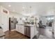 Bright open-concept kitchen with stainless steel appliances, a central island, and seamless flow to the living areas at 14670 Guernsey Dr, Mead, CO 80542