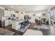Modern kitchen with stainless steel appliances, a center island with seating, and an adjacent dining area with a backyard view at 14670 Guernsey Dr, Mead, CO 80542