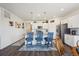 Modern kitchen with white cabinets, stainless steel appliances, pendant lighting, and a center island with barstool seating at 14670 Guernsey Dr, Mead, CO 80542