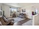 Cozy living room with a comfortable seating arrangement, large windows, stylish decor, and ample natural light at 14670 Guernsey Dr, Mead, CO 80542