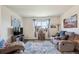 Comfortable living room with natural light, stylish furnishings, a large window, and a relaxed atmosphere at 14670 Guernsey Dr, Mead, CO 80542