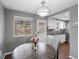 Dining area with table set for four, with a view into the kitchen and backyard beyond at 18093 E Milan Pl, Aurora, CO 80013
