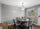 Cozy dining area with a round table, four chairs, hardwood flooring, and decorative lighting at 18093 E Milan Pl, Aurora, CO 80013