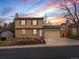 Charming two-story home featuring brick and vinyl siding, complemented by a landscaped front yard and an attached two-car garage at 18093 E Milan Pl, Aurora, CO 80013