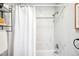 Well-lit bathroom with a shower-tub combo featuring sleek, bright, marble-look tiles and modern fixtures at 4110 Hale Pkwy # 3K, Denver, CO 80220