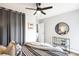 Bright bedroom featuring a ceiling fan, neutral decor, and a view into the ensuite bath at 4110 Hale Pkwy # 3K, Denver, CO 80220