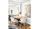 Charming dining area with a round wood table, seating for four, and a decorative mirror at 4110 Hale Pkwy # 3K, Denver, CO 80220