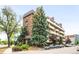 A lovely brick apartment building with mature trees and manicured landscaping at 4110 Hale Pkwy # 3K, Denver, CO 80220