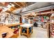 Unfinished basement workshop features a pegboard, work bench, shelving, and ample storage space at 1820 Sapling Ct, Castle Rock, CO 80109