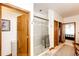 Bathroom featuring tiled shower with glass door, tile flooring, and access to the main bedroom at 1820 Sapling Ct, Castle Rock, CO 80109