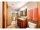 Bathroom featuring tile flooring, shower with glass door, and wooden vanity with granite countertop at 1820 Sapling Ct, Castle Rock, CO 80109