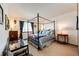Well-lit bedroom with a four-poster bed, bright window, and a side table with lamp at 1820 Sapling Ct, Castle Rock, CO 80109