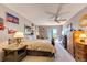 Cozy bedroom with a sliding glass door to a balcony, ceiling fan and sports memorabilia at 1820 Sapling Ct, Castle Rock, CO 80109
