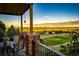 The outdoor deck features a table, chairs, and incredible views of the golf course and surrounding landscape at 1820 Sapling Ct, Castle Rock, CO 80109