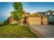 Charming two-story home featuring a well-manicured lawn and a three-car garage at 1820 Sapling Ct, Castle Rock, CO 80109