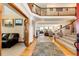 Elegant foyer with wood flooring, a grand staircase, and views into the spacious living areas at 1820 Sapling Ct, Castle Rock, CO 80109