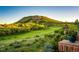 Scenic view of lush green golf course and hillside from a private outdoor space at 1820 Sapling Ct, Castle Rock, CO 80109