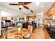 Open concept kitchen with wood cabinets, granite countertops, black appliances, and a view to the living area at 1820 Sapling Ct, Castle Rock, CO 80109