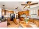 Charming kitchen with wood cabinets, granite countertops, stainless steel appliances, and a breakfast nook at 1820 Sapling Ct, Castle Rock, CO 80109