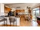 Well-lit kitchen with wood cabinets, granite countertops, stainless steel appliances, and an adjacent dining area at 1820 Sapling Ct, Castle Rock, CO 80109