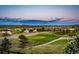 Scenic view of a golf course and neighborhood against a twilight sky at 1820 Sapling Ct, Castle Rock, CO 80109
