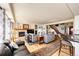 Open-concept living space with a cozy fireplace, hardwood floors, and staircase to the upper level at 1820 Sapling Ct, Castle Rock, CO 80109