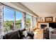 Bright living room with a fireplace and sliding glass doors that open to a scenic deck with mountain views at 1820 Sapling Ct, Castle Rock, CO 80109