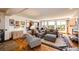 Bright and airy living room featuring hardwood floors, comfortable seating, and views of the surrounding landscape at 1820 Sapling Ct, Castle Rock, CO 80109