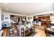 Spacious living room featuring hardwood floors, a cozy seating area, and an open layout to the kitchen at 1820 Sapling Ct, Castle Rock, CO 80109