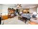 Bright living room featuring neutral tones, wood shelving, a ceiling fan, and a comfortable sofa at 1820 Sapling Ct, Castle Rock, CO 80109