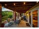 Relaxing covered patio with brick pillars, string lights, and comfortable seating for outdoor enjoyment at 1820 Sapling Ct, Castle Rock, CO 80109