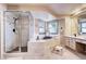 Elegant bathroom with corner soaking tub, walk-in shower, and double sinks at 10697 W Roxbury Ave, Littleton, CO 80127