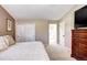 Spacious bedroom with double doors leading to the bathroom and a large closet at 10697 W Roxbury Ave, Littleton, CO 80127